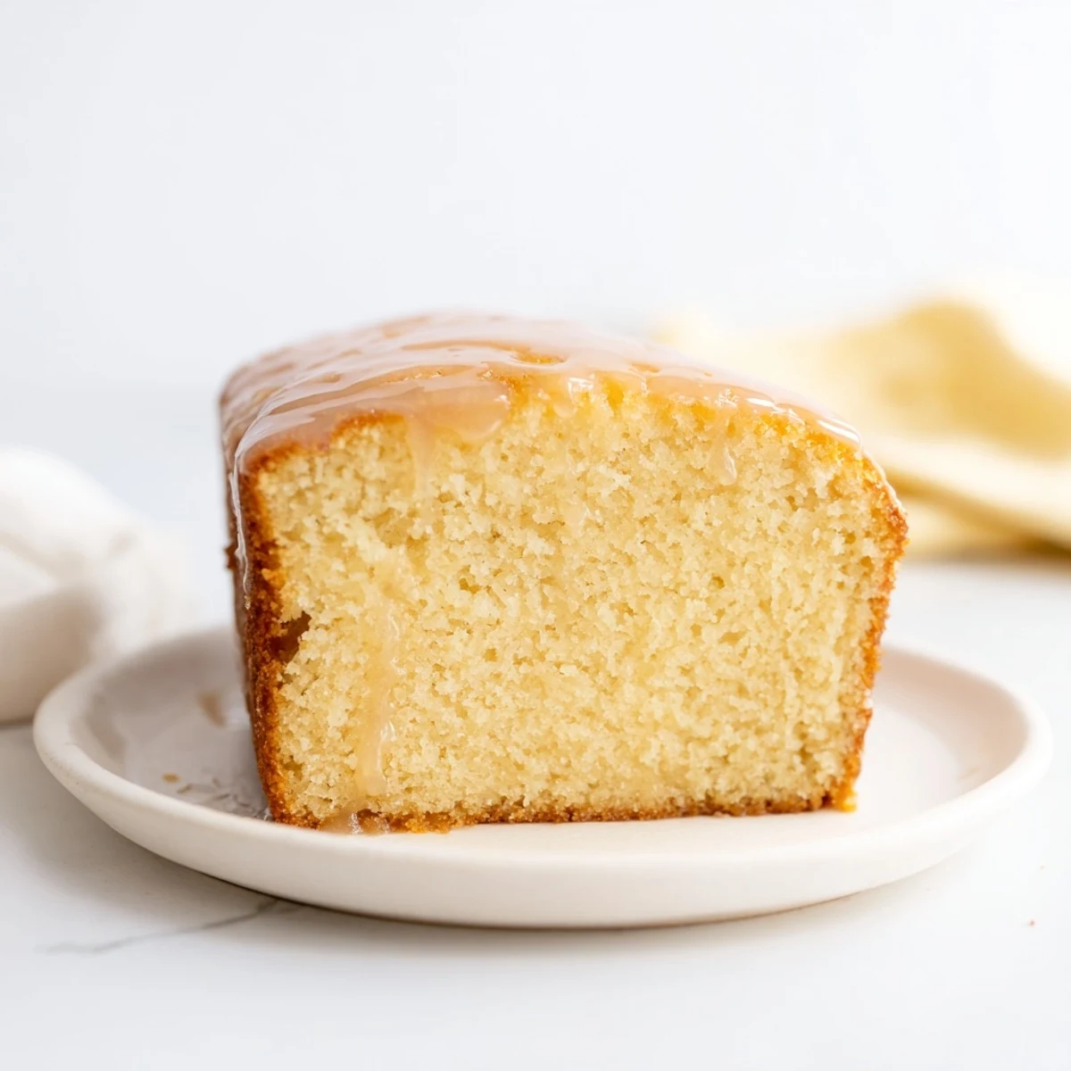 Soft glow golden honey pound cake, sliced and ready to serve, is moist and fragrant with honey.