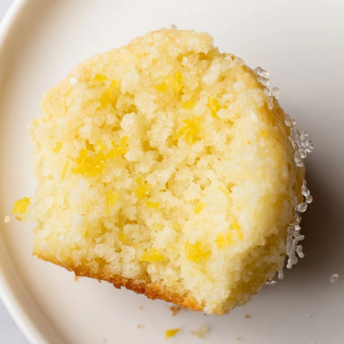 Freshly baked Simple Sweet Lemon Zest Muffins, smelling of bright citrus, ideal for breakfast or a snack.