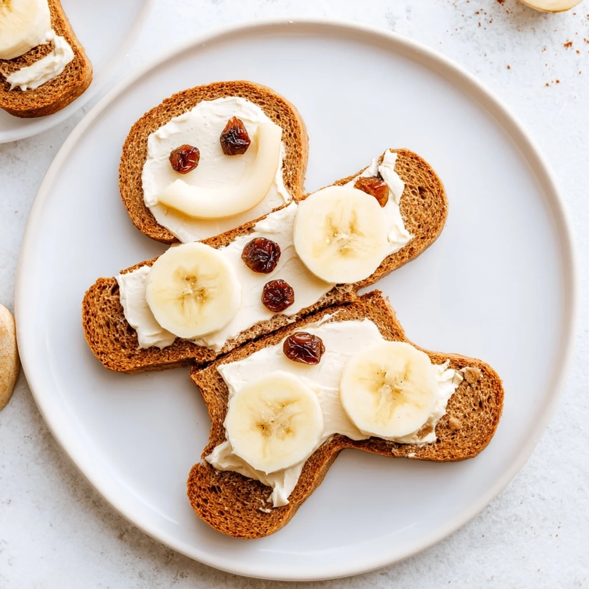Gingerbread man sandwich cutouts with bright apple smiles and raisin eyes, a fun kids lunch!