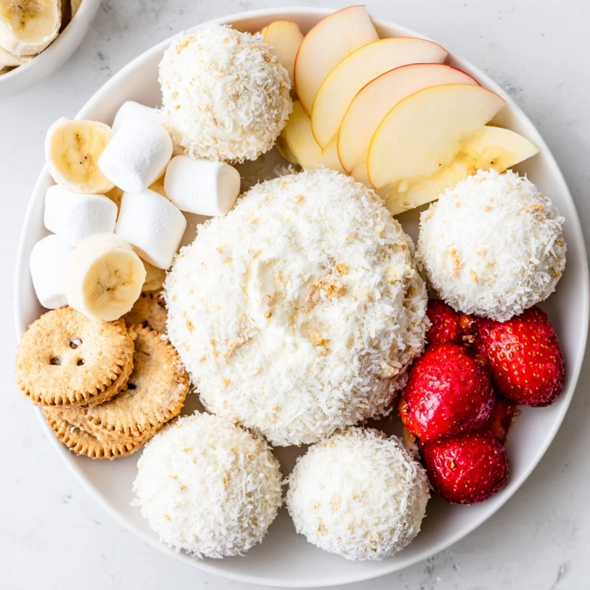 Creamy Marshmallow Snowball Dip Platter, perfect for dipping fruits and pretzels at any kids' party.