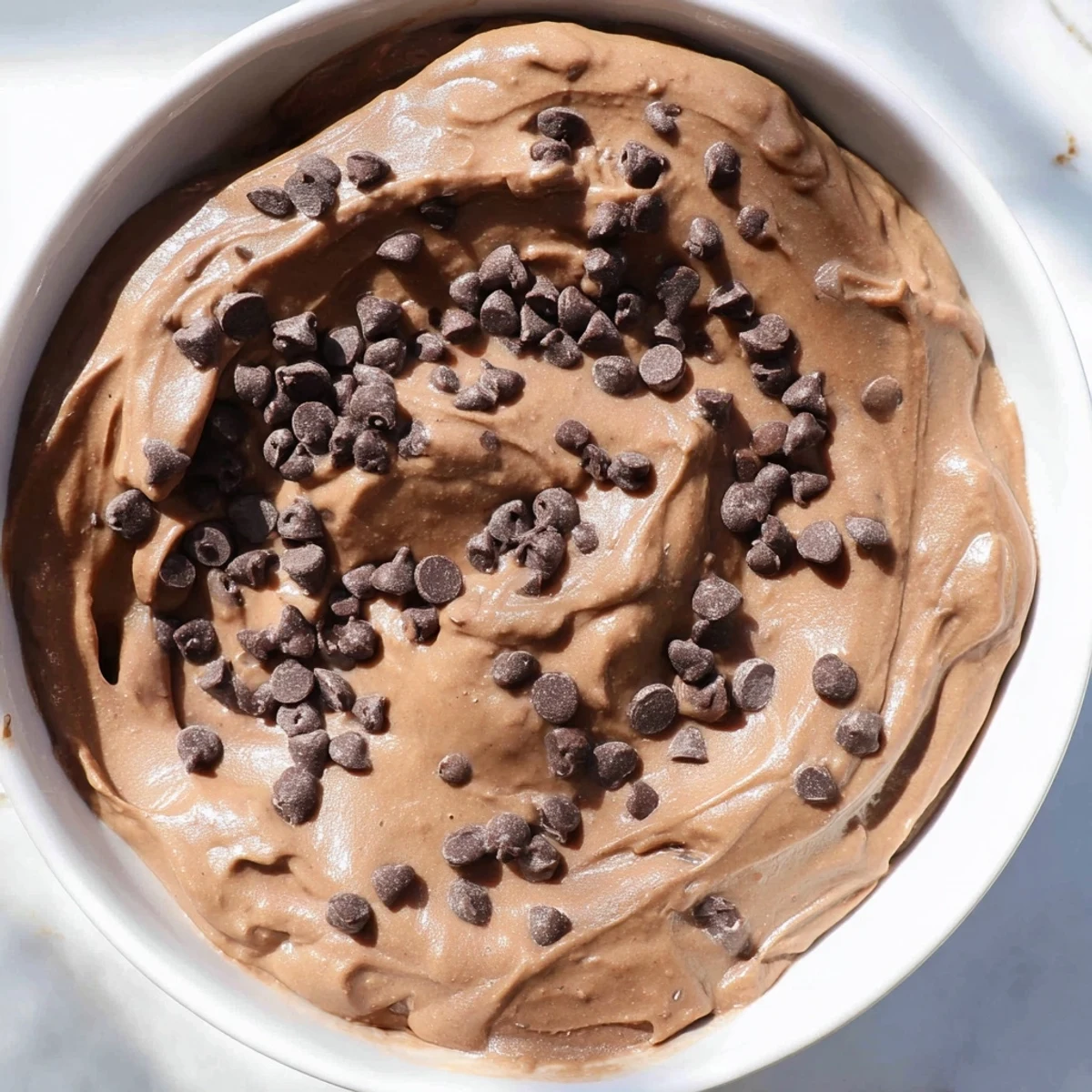 Creamy, gluten-free Brownie Batter Dip overflowing in a bowl, perfect for your next dessert recipe.