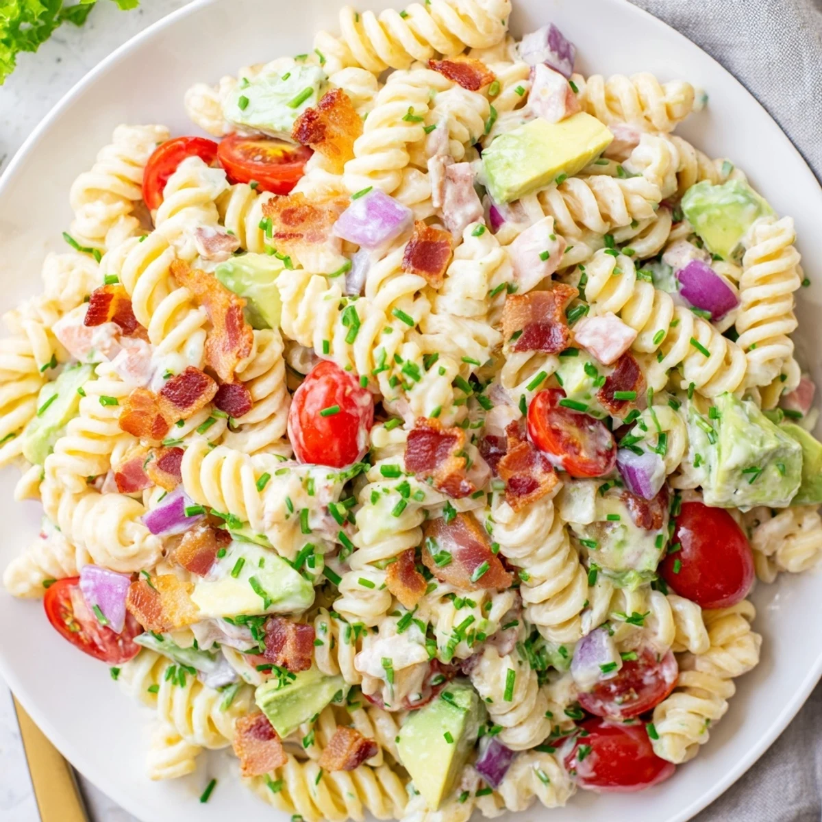 BLT Pasta Salad, a creamy, flavorful dish with crispy bacon, fresh tomatoes, and vibrant lettuce.