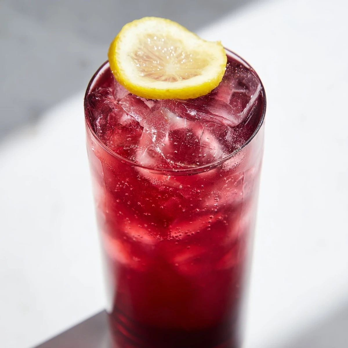 Enjoy a refreshing Sleepy Girl Mocktail, showcasing the tart cherry juice with a lemon garnish.