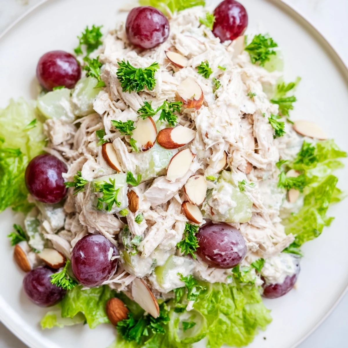 A bowl of creamy Crispy Chicken Salad with grapes and fresh, vibrant salad greens.