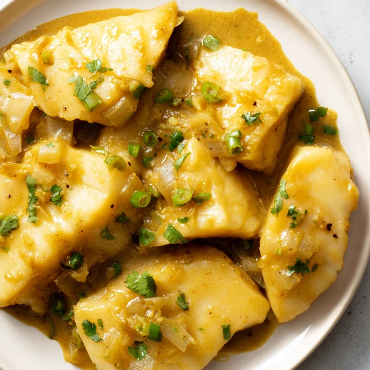 This beautiful Bahraini Fish Curry shows tender fish chunks simmering in a vibrant spiced coconut broth.