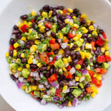 A refreshing bowl of Southwest Black Bean Salad, full of crunchy vegetables and creamy avocado.
