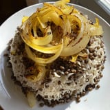 Golden caramelized onions crown this Lebanese Mjadra, a hearty vegan meal with fluffy rice.