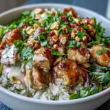 Golden sautéed chicken and crisp veggies sit on fluffy coconut rice in a Peanut Chicken Protein Bowl, drizzled with creamy peanut sauce.