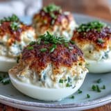 Golden deviled eggs topped with lump crab meat and a dusting of zesty Old Bay.  