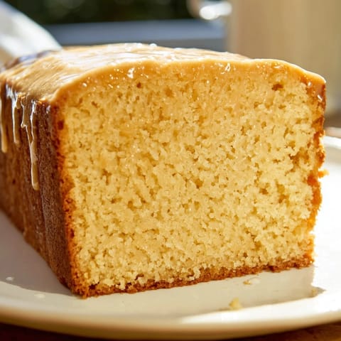 A warm slice of honey pound cake, golden-brown and textured, is perfect for dessert.