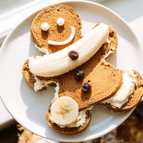 Festive gingerbread man sandwich cutouts freshly made, filled with creamy cheese and fruit.