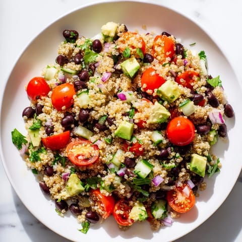 Chilled Quinoa Black Bean Salad with juicy tomatoes, perfect for a summer lunch.