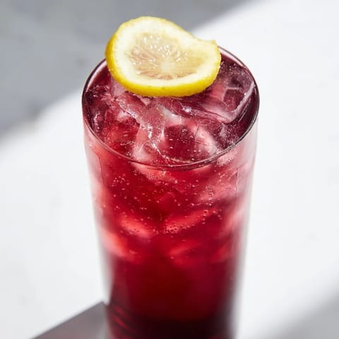 Enjoy a refreshing Sleepy Girl Mocktail, showcasing the tart cherry juice with a lemon garnish.