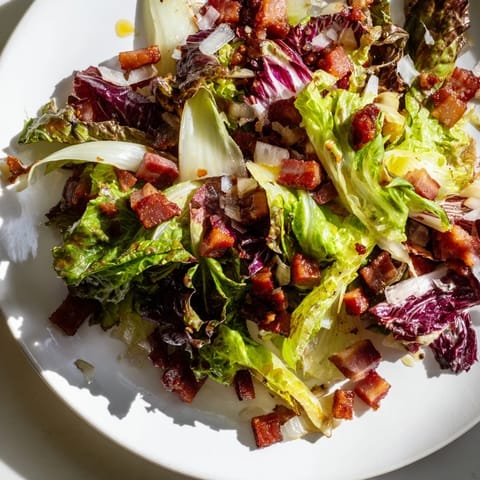 Imagine the warm, smoky bacon dressing gently wilting the fresh Bitter Greens Salad.