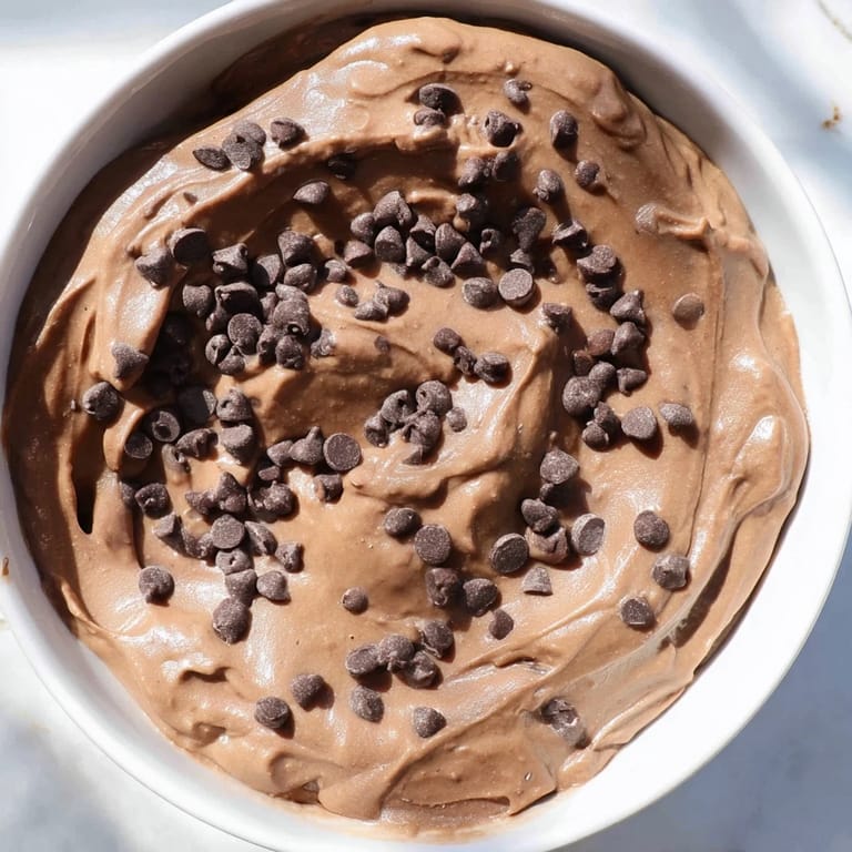 Creamy, gluten-free Brownie Batter Dip overflowing in a bowl, perfect for your next dessert recipe.