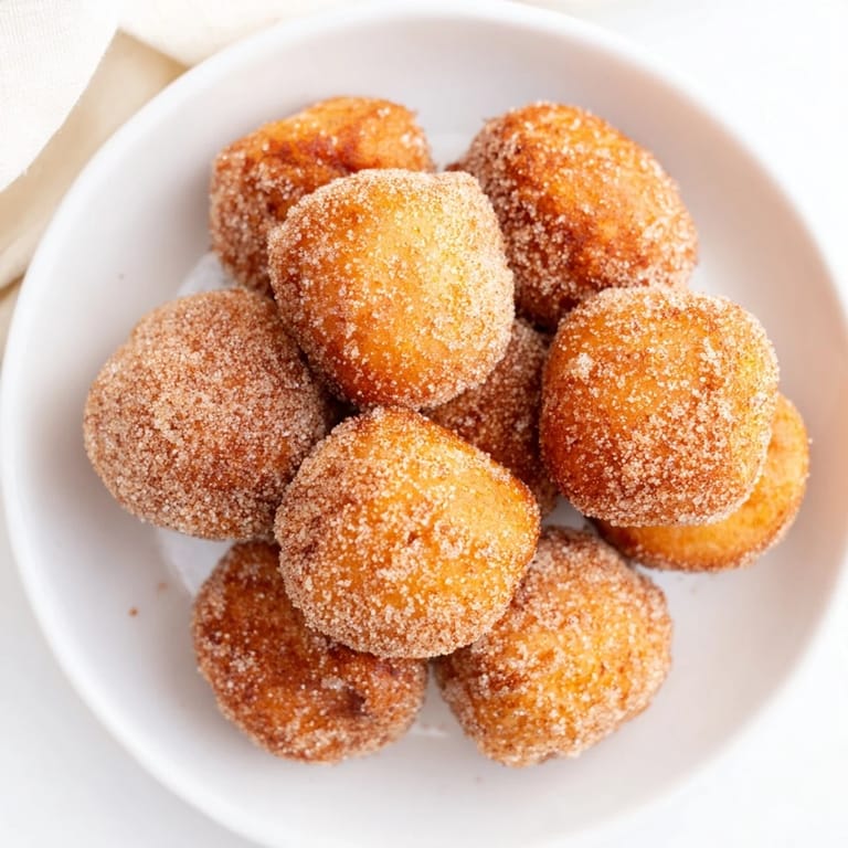 Close-up of fluffy air fryer cinnamon donuts, showing the perfect texture and delightful cinnamon coating.