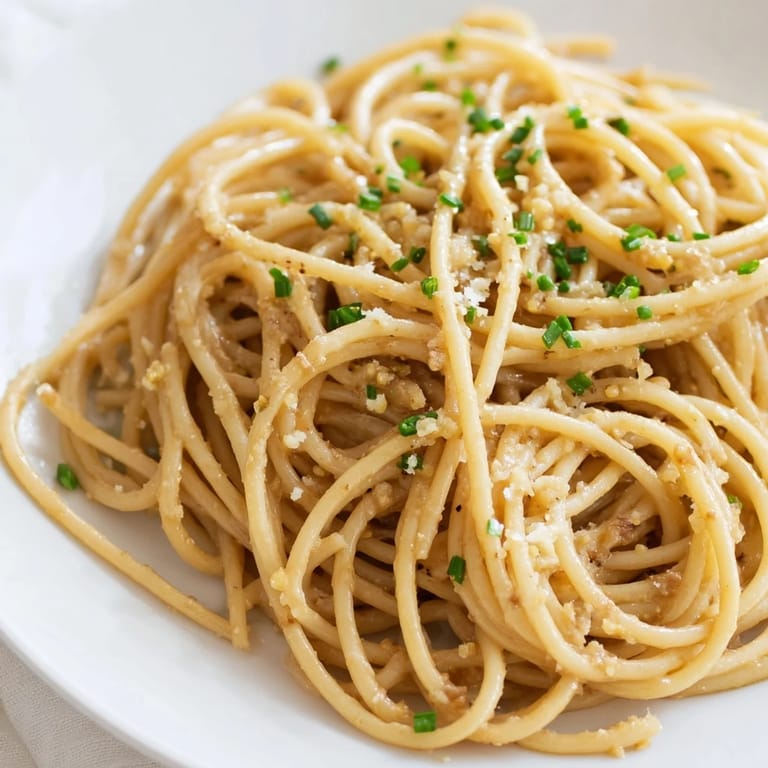 Fresh chives garnish this comforting Miso Butter Pasta dish, ready for a flavorful bite of umami goodness.