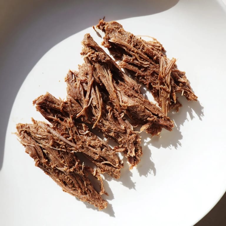 A steaming plate of Omani Shuwa: juicy, flavorful lamb cooked to perfection and served with rice.