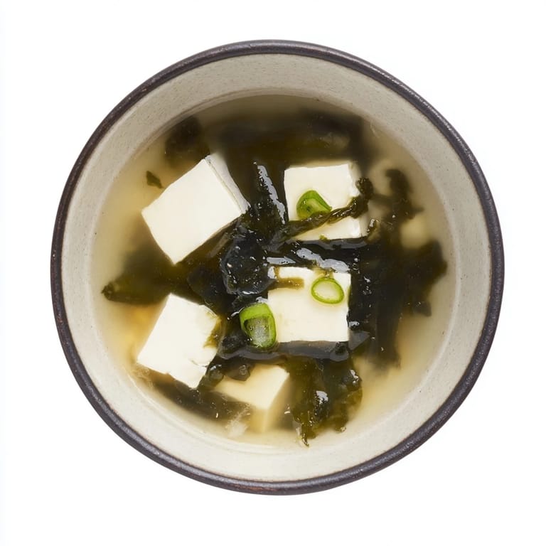 Close-up of Miso Soup With Tofu featuring silky tofu cubes and tender seaweed.
