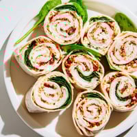 Beautifully presented Sun-Dried Tomato Turkey Roll-Ups, ready to eat; a vibrant lunch or snack.